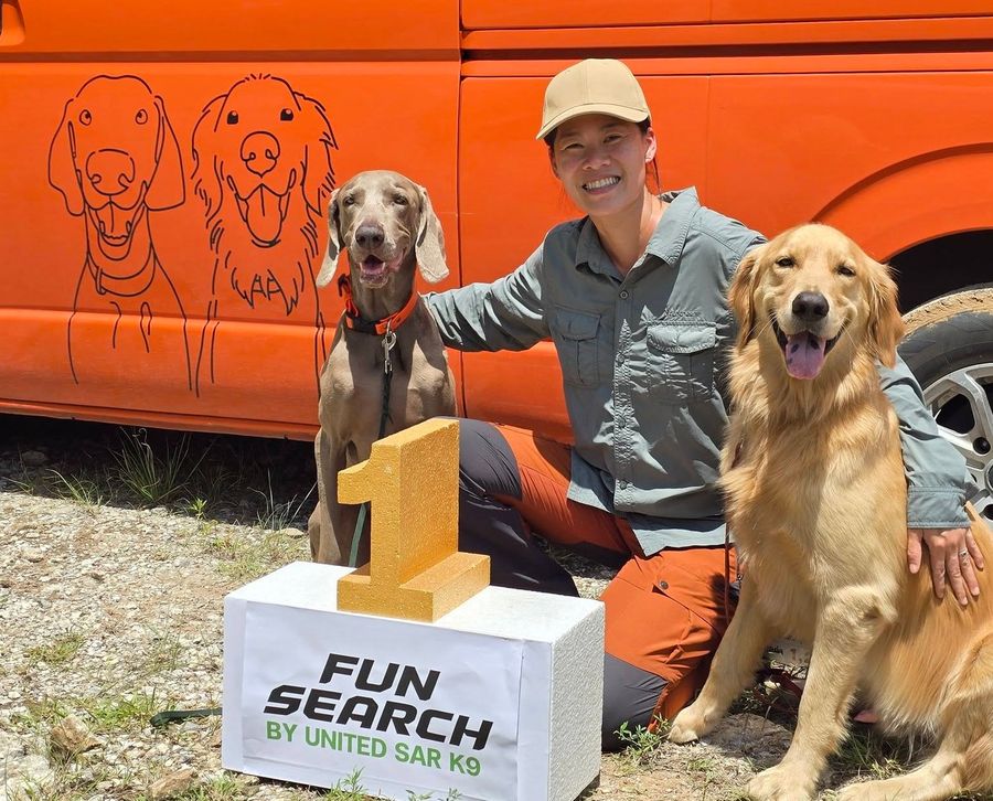 Natt Hamon with her dogs celebrating first place in the Fun Search competition by United SAR K9, for the Hua Hin Dog Training Facebook page